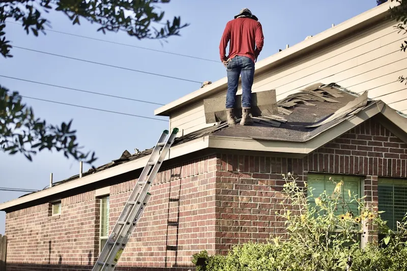 Professional roofer working on a residential roof in Lake Hills